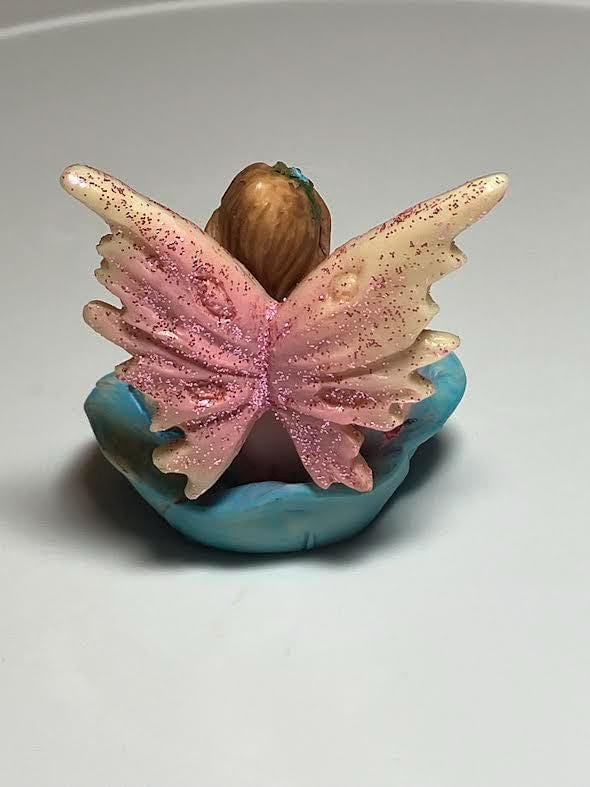 Miniature Pink Wing Fairy Sitting on a Blue Flower